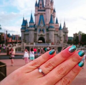 Engagement ring in front of Disney Castle