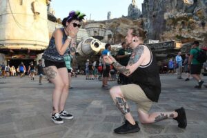 Engaged couple in front of Millennium Falcon